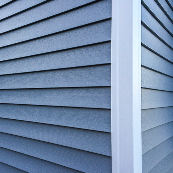 grey siding of a house with white corner