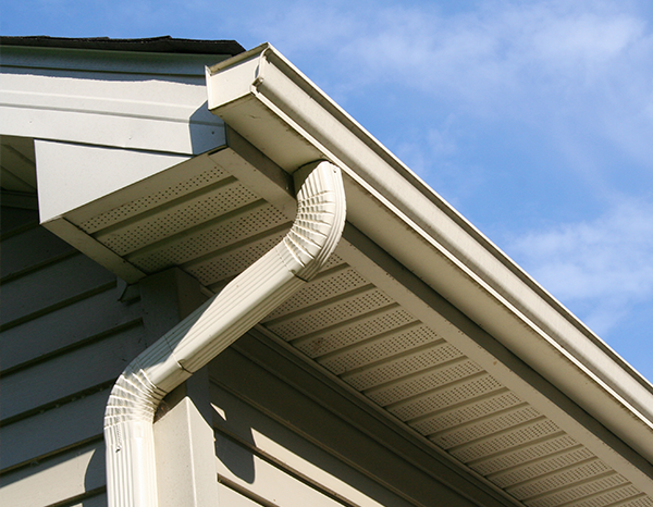 side of a house showcasing a gutter with piping