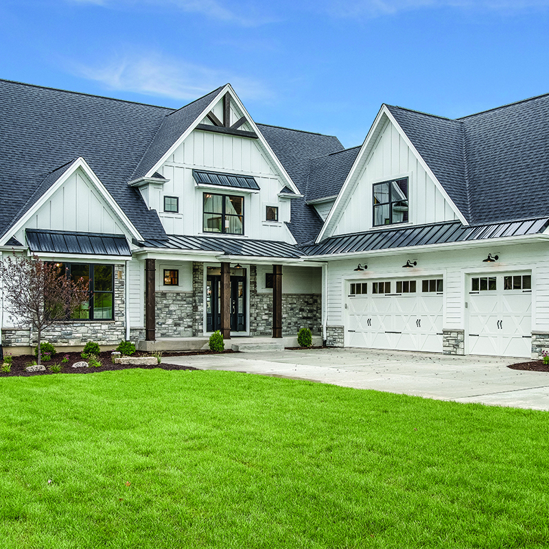 a large green field in front of a house